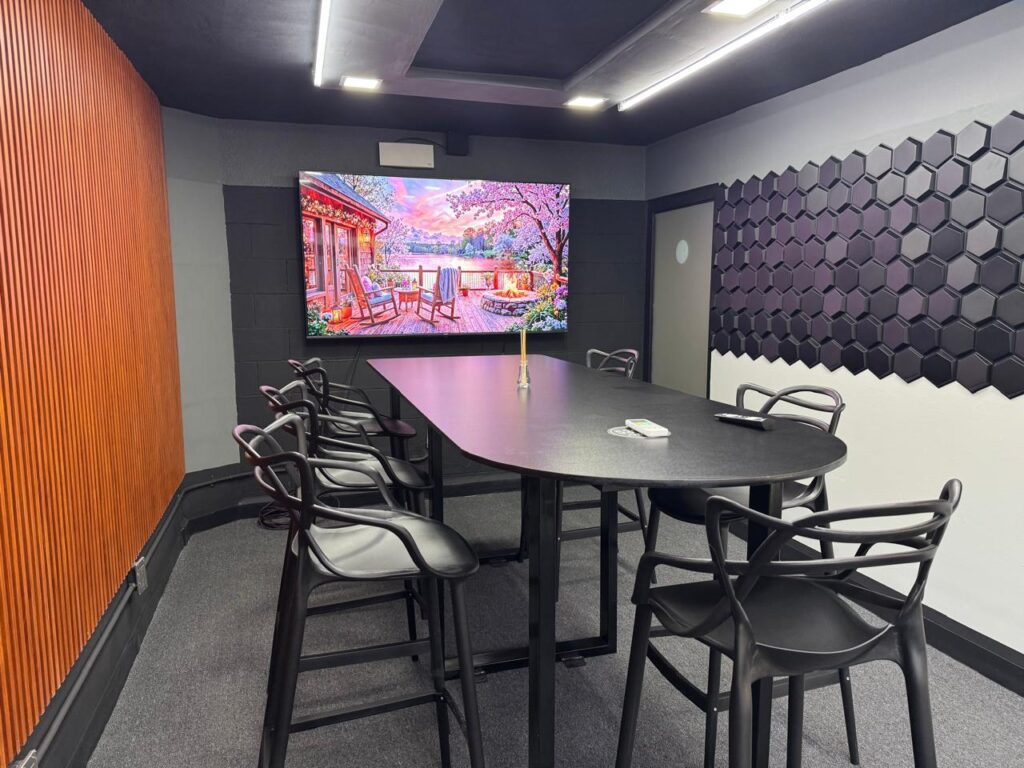 Sala Nexus de 53100 Network, con mesa ovalada y sillas negras